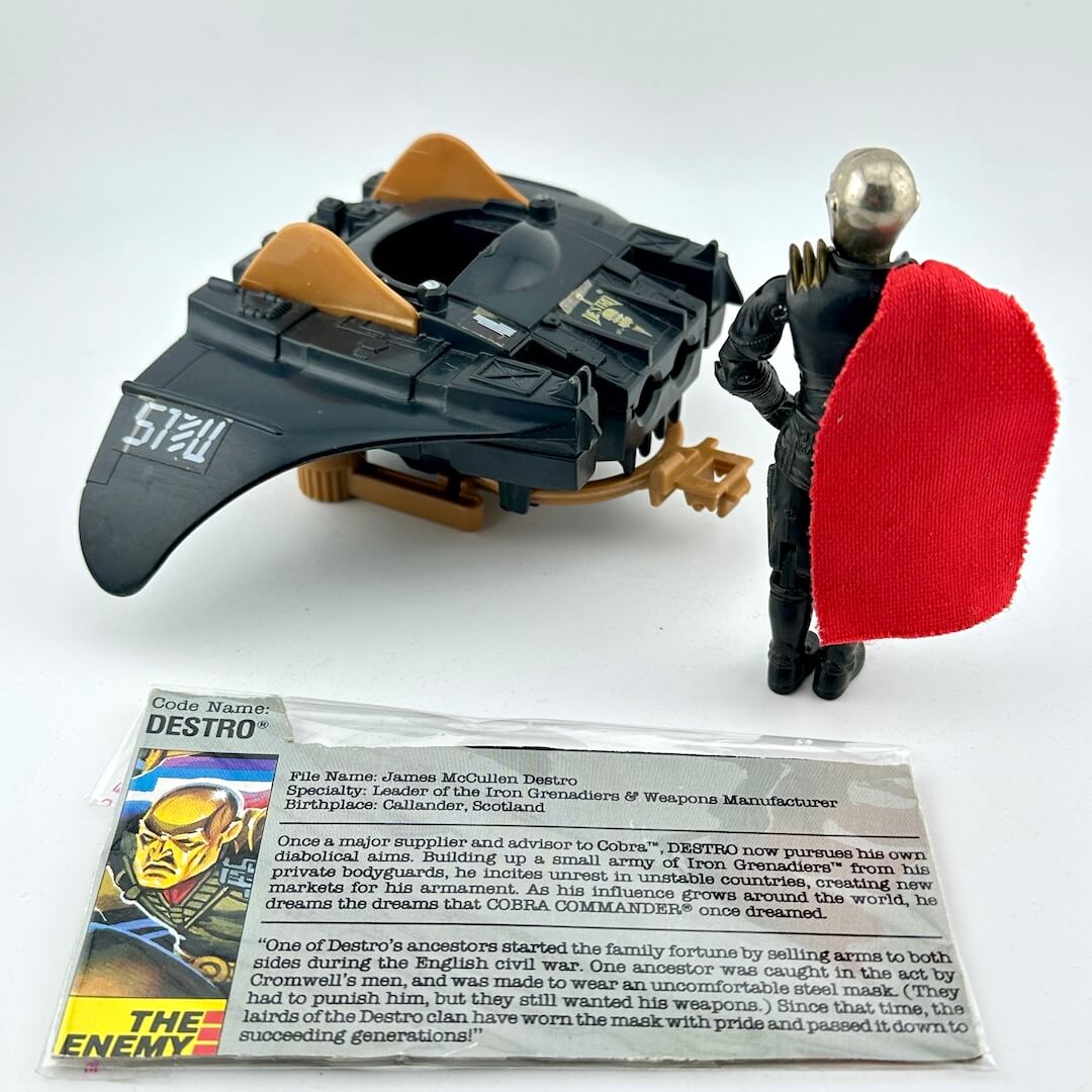 Toy figure with a weapon and shield, accompanied by a character card on a white background