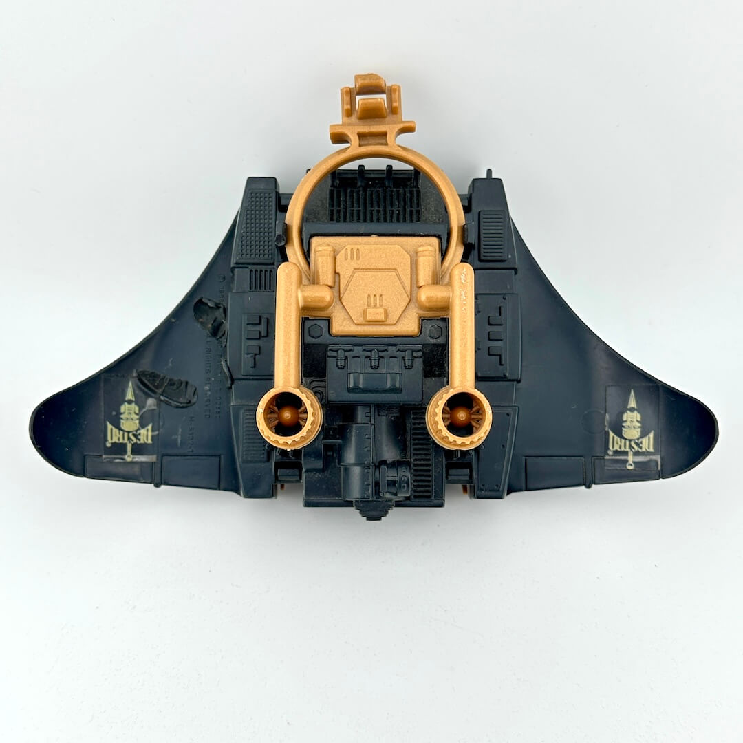 Toy spaceship with gold and black design on a white background