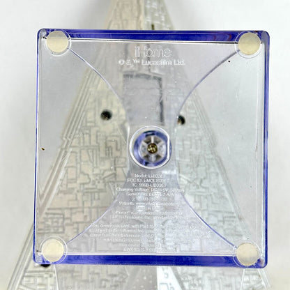 A square clear acrylic stand with rounded corners, featuring printed text including 'iHome' and 'Innova Logic Vision Ltd.'