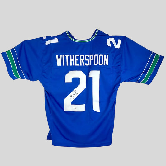 Blue football jersey with white nameplate "Witherspoon" and number "21" on white background. 