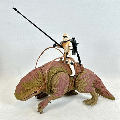 Toy figure of a stormtrooper on a creature with a white background
