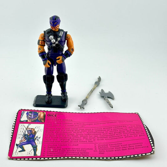 Toy figure with accessories and a pink card on a white background