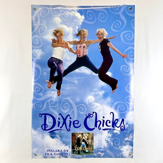 Promotional poster for Dixie Chicks with three women jumping against a blue sky.