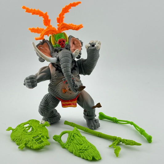 Anthropomorphized elephant dressed like "witch doctor" with orange headdress, with lime green accessories.