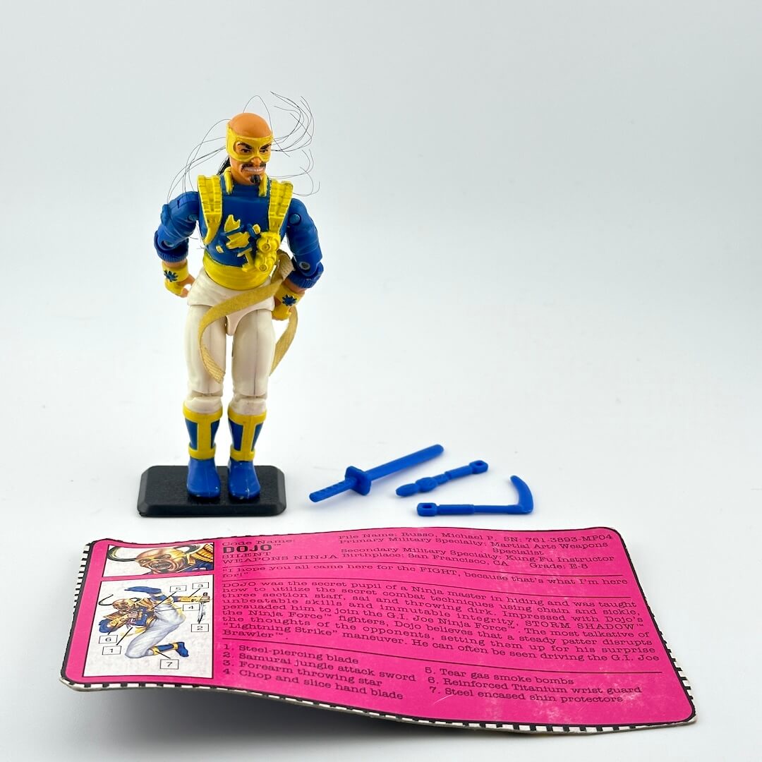 G.I. Joe action figure with accessories and character card against white background.