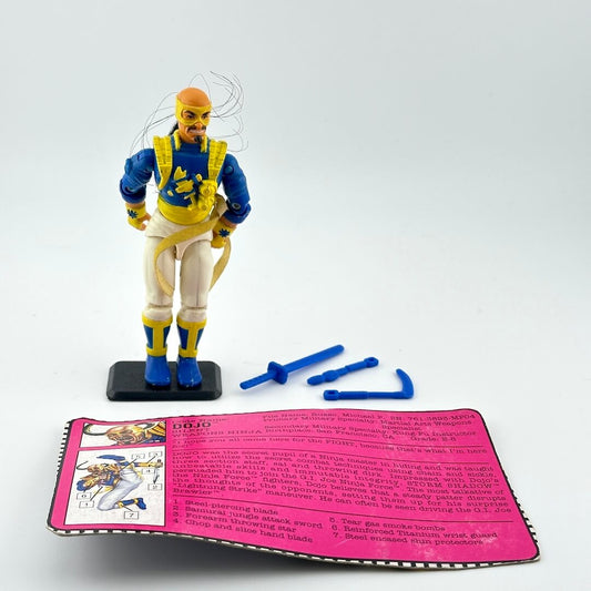 G.I. Joe action figure with accessories and character card against white background.