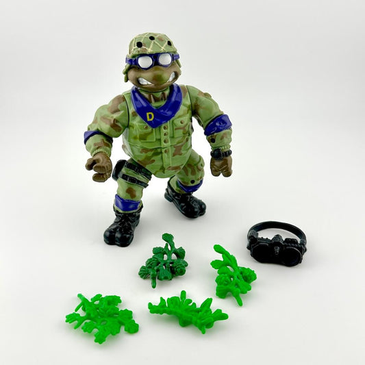 Toy figure in green military uniform with accessories on a white background