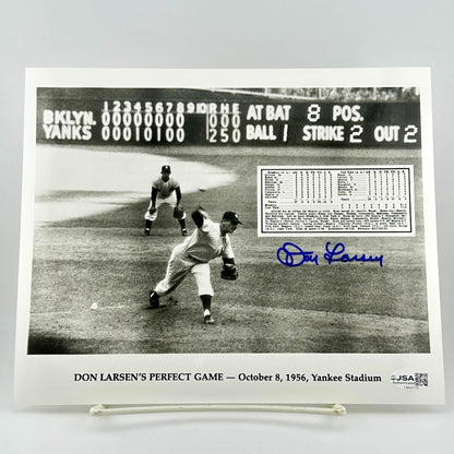 Black and white photo of a baseball game with Don Larsen's signature and details about his perfect game.