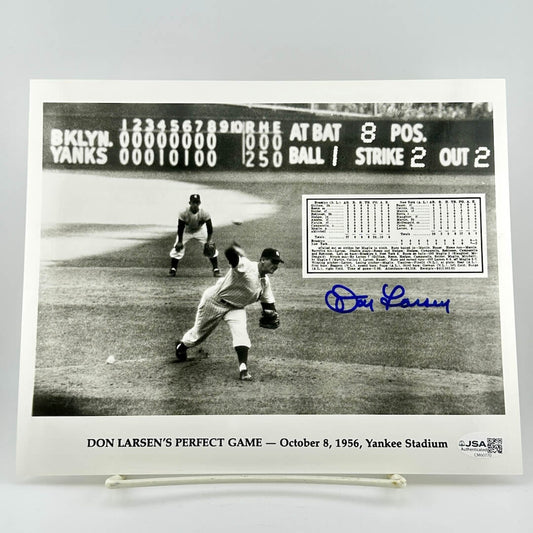 Black and white photo of a baseball game with Don Larsen's signature and details about his perfect game.