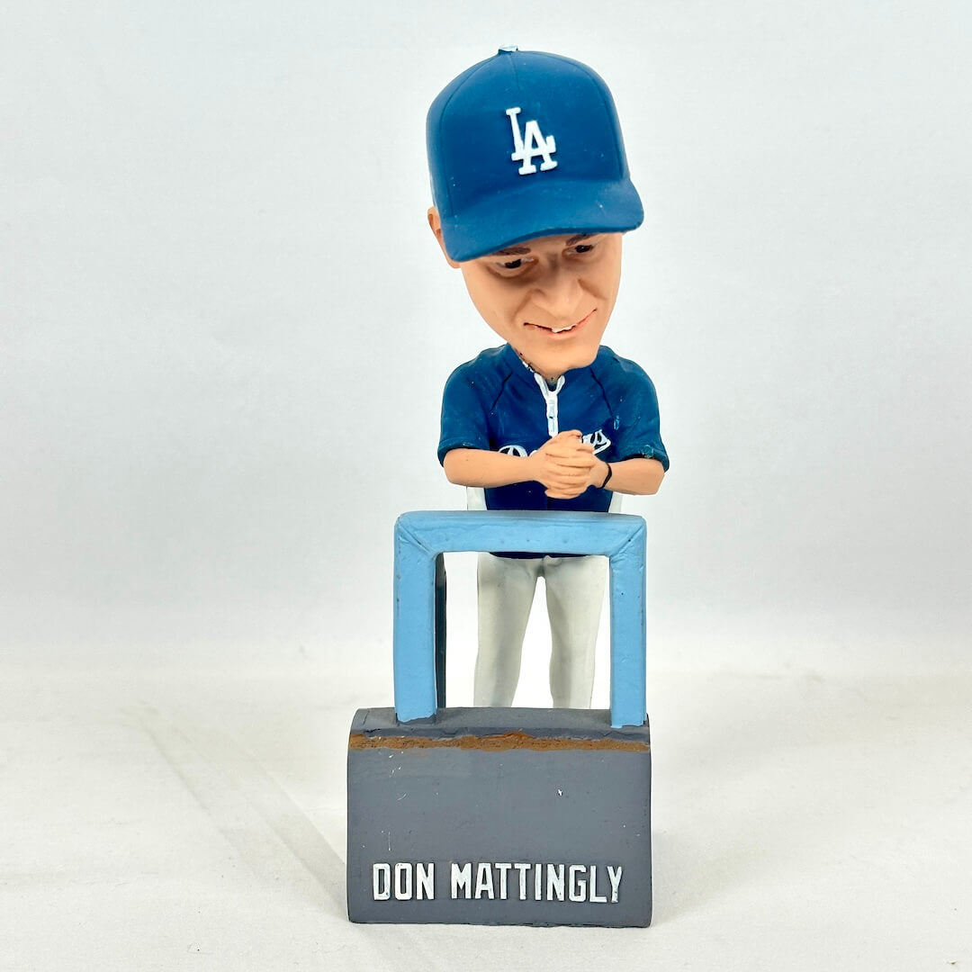 A bobblehead figurine of baseball player Don Mattingly in a blue Los Angeles Dodgers uniform and cap.