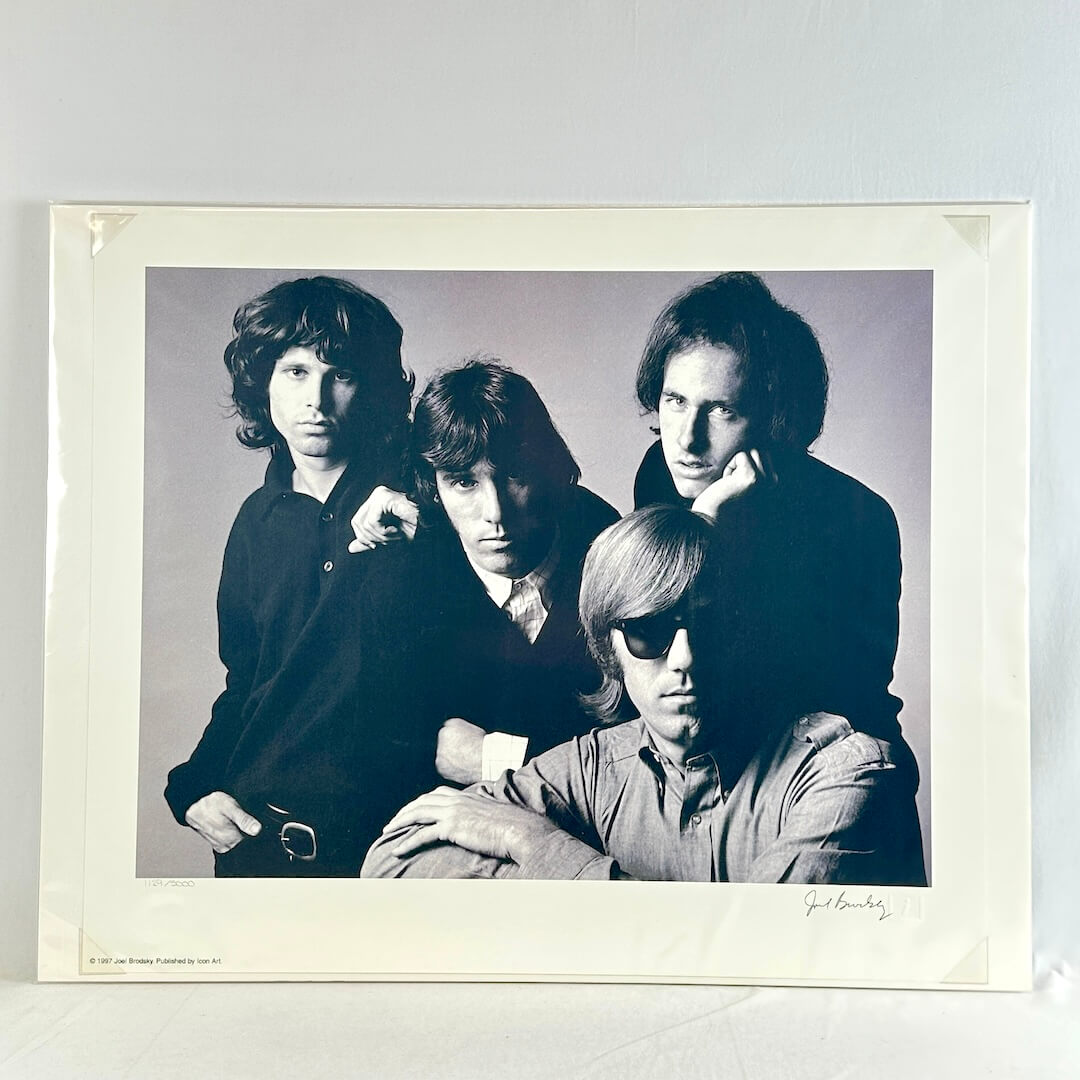 black and white photograph of a group of four people against a plain background