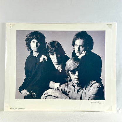 black and white photograph of a group of four people against a plain background