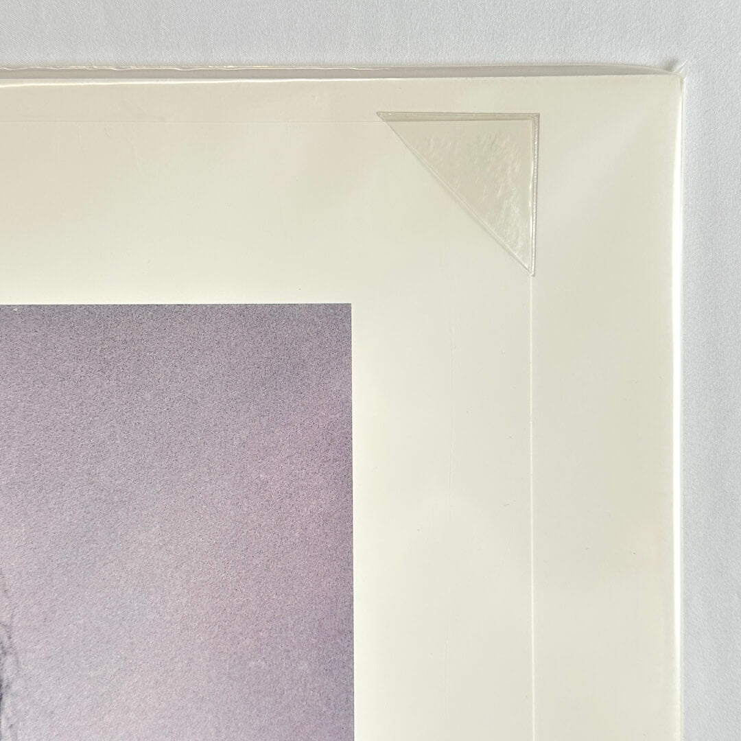 Top right corner of print tucked into protective corner, sleeved in plastic. 
