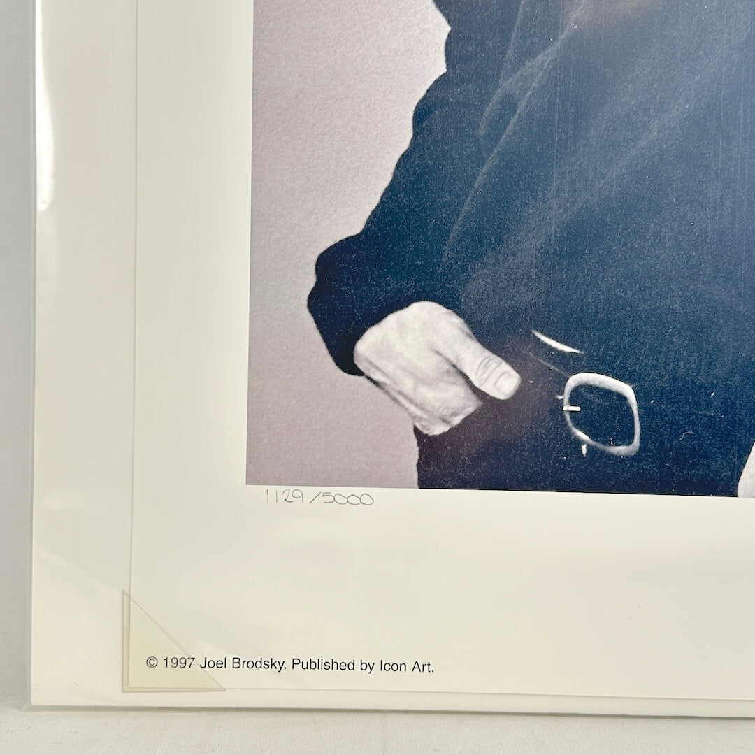 Bottom left corner of print tucked into protective corner, sleeved in plastic. 