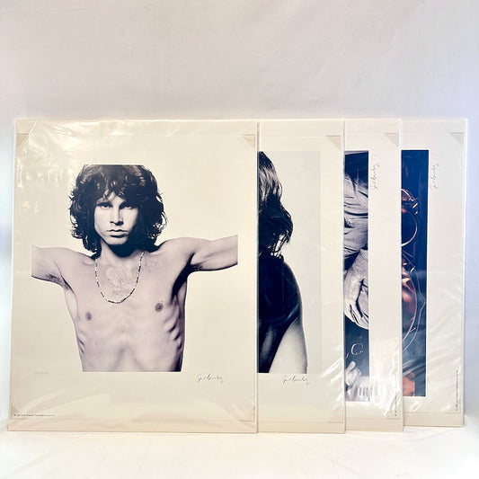 Set of four lithographic prints in plastic sleeves against white background. 
