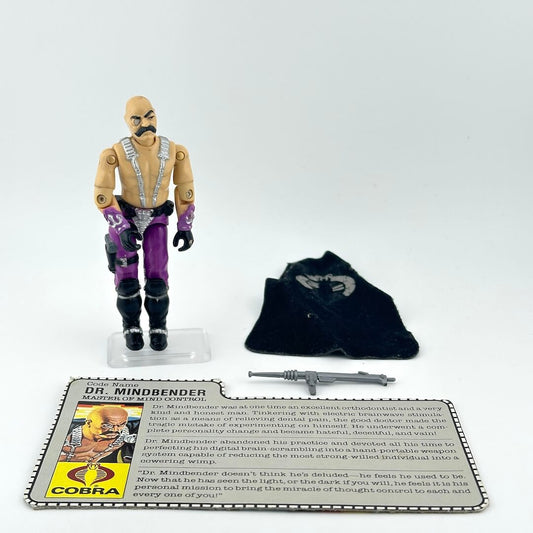 Toy figure of Dr. Mindbender with accessories and card on a white background