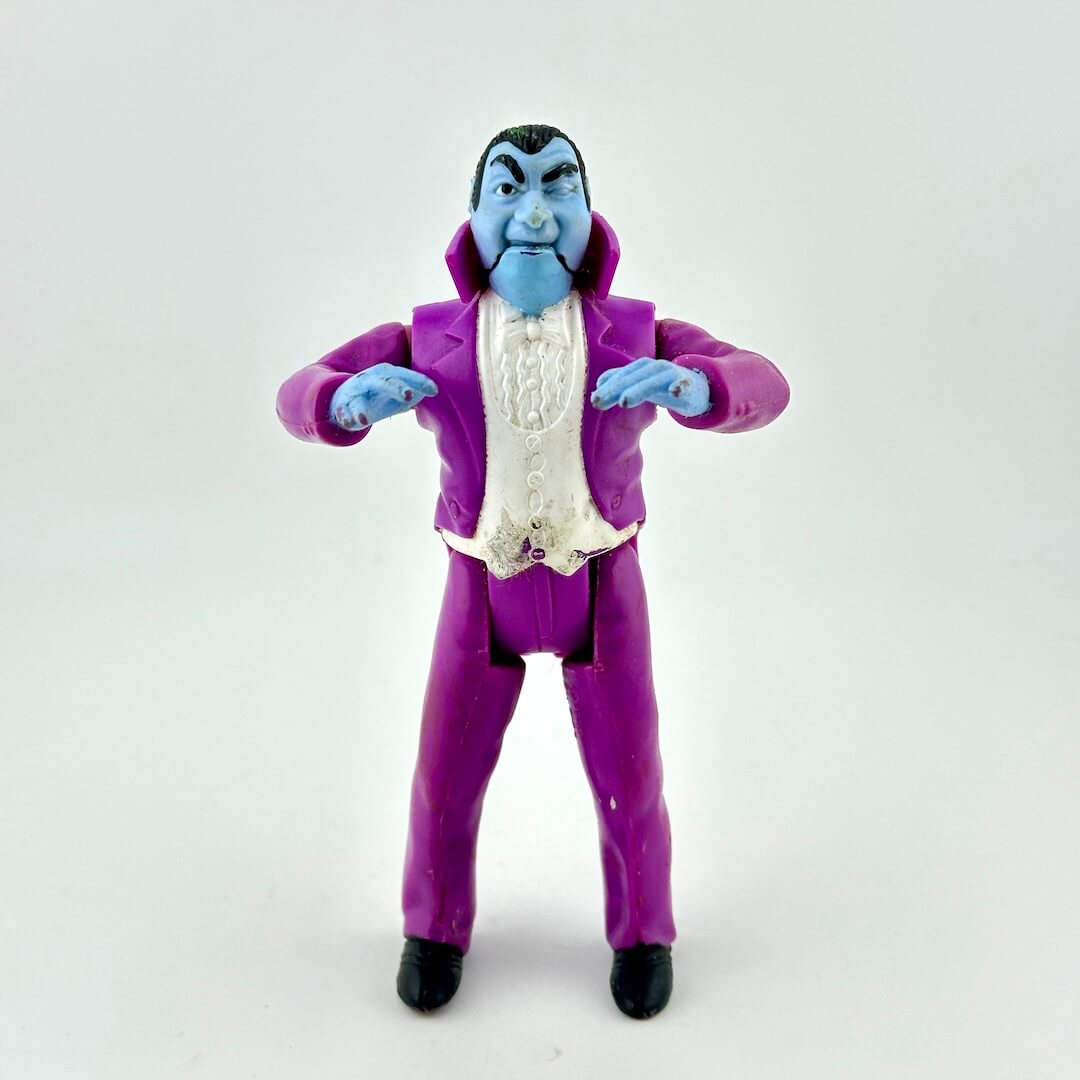 Toy figure of a character in a purple suit on a white background