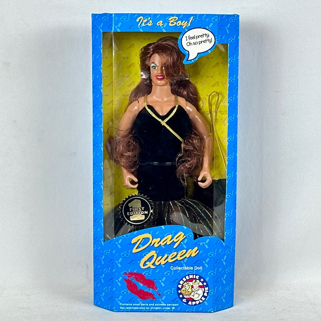 Boxed collectible doll labeled 'Drag Queen' with blue and yellow packaging.