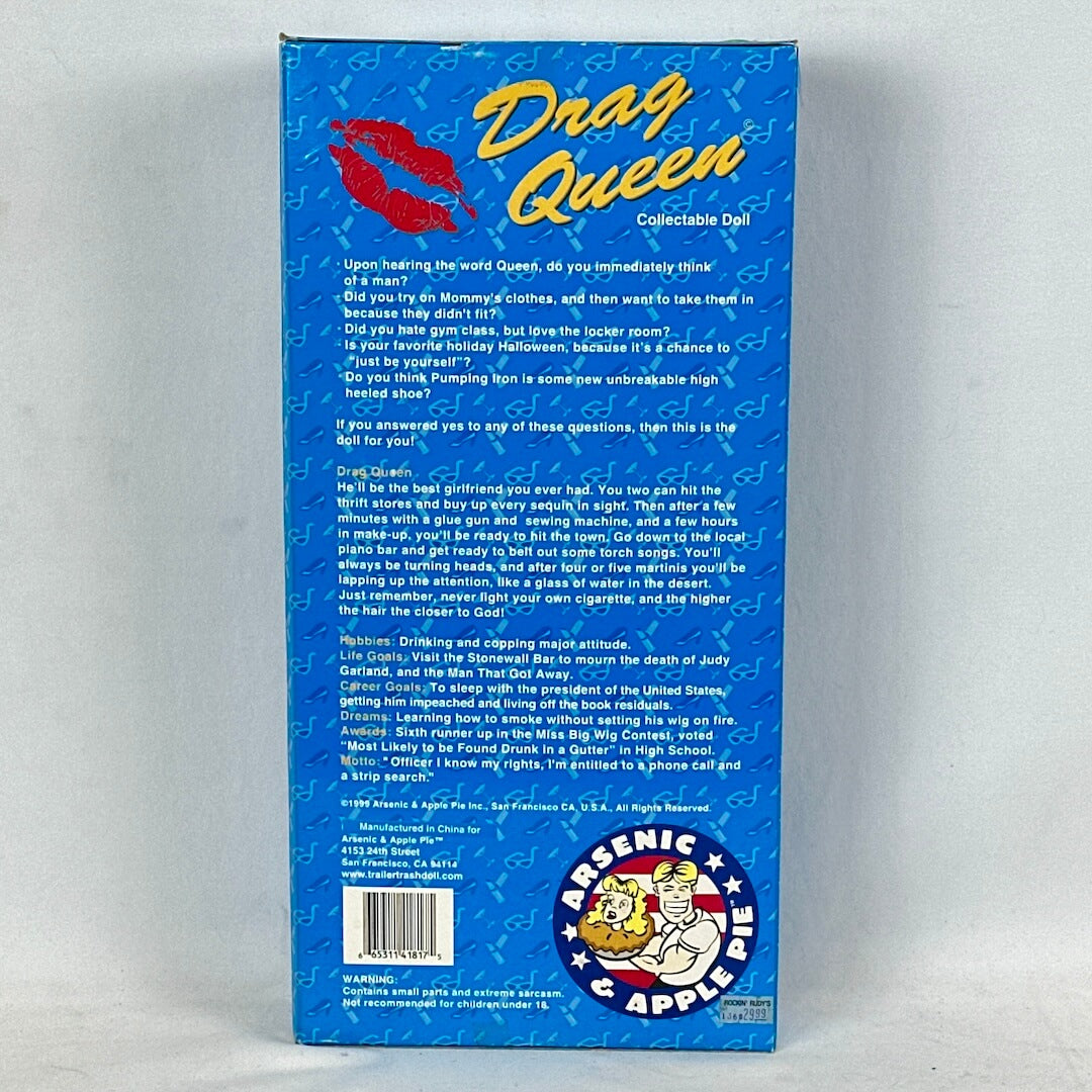 Back of a blue box featuring 'Drag Queen' collectible doll with text and Arsenic & Apple logo.
