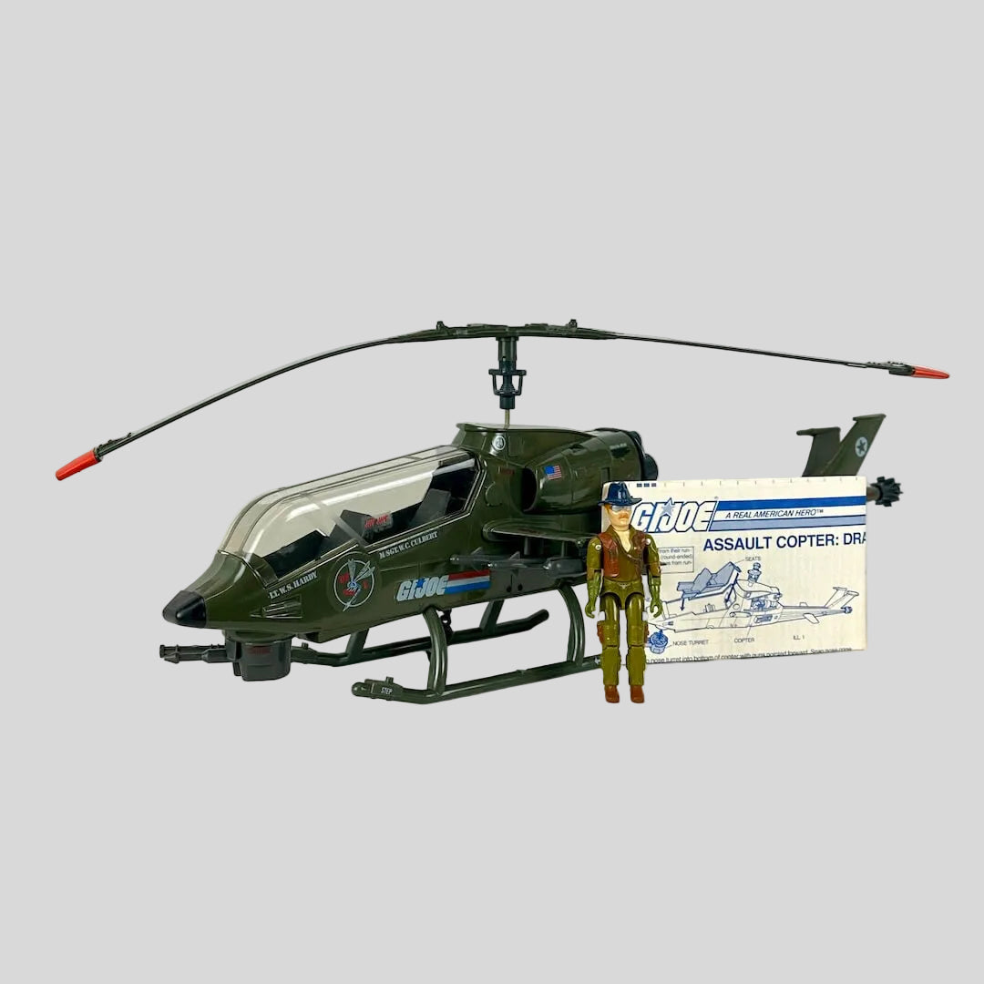 A vintage G.I. Joe action figure and toy helicopter with instructions on white background. 