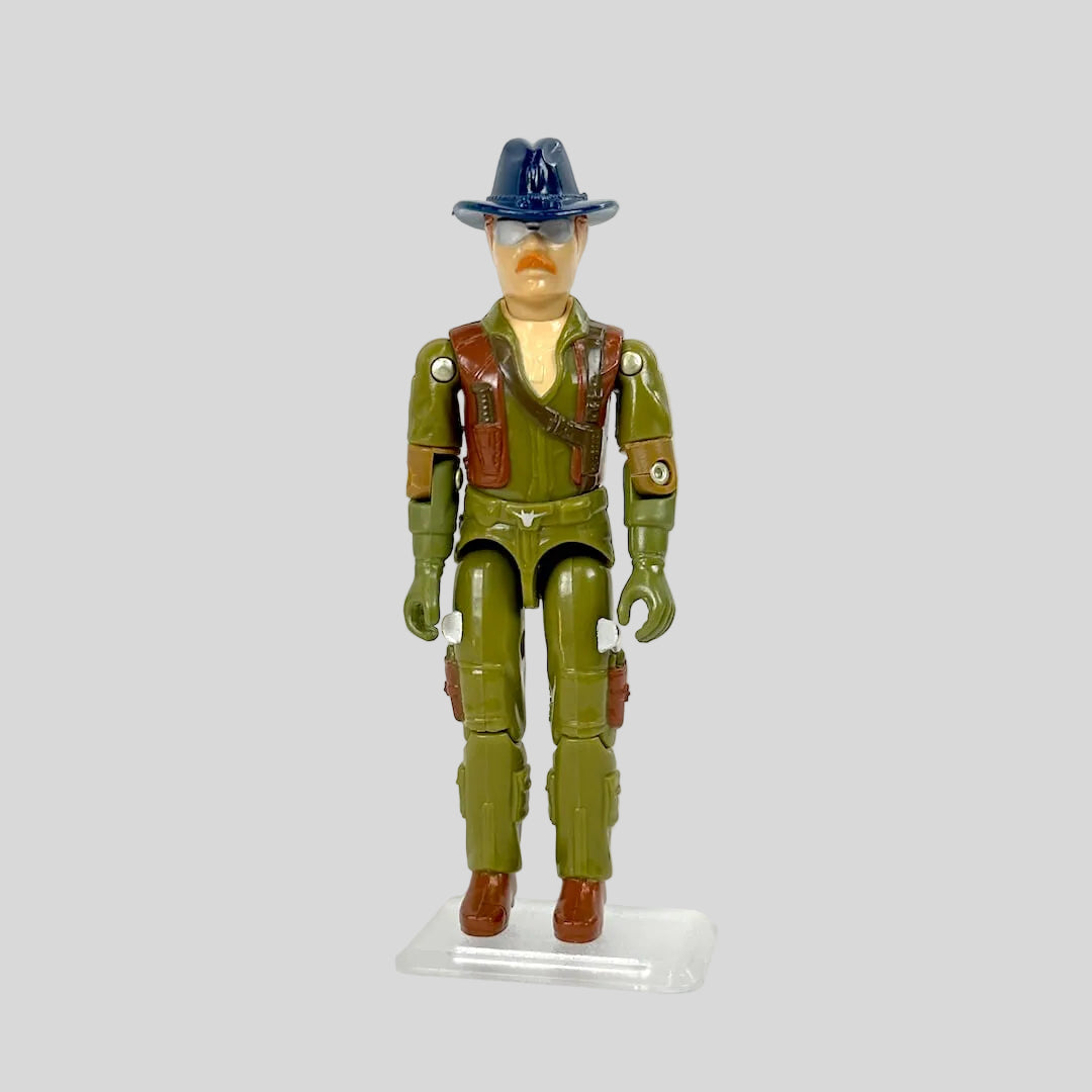 Action figure in green uniform with hat on a white background