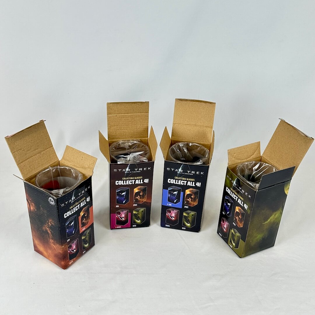 Four colorful boxes with spaceship graphics against white background. View of them open to show glasses