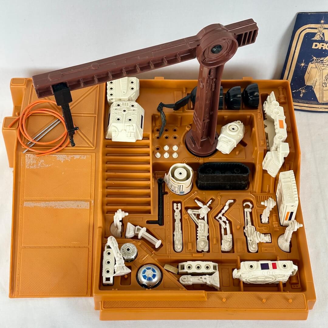Toy robot kit with various components on an orange tray