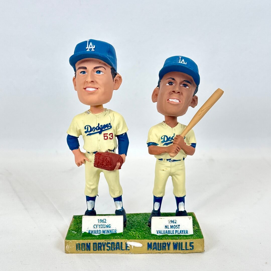 A pair of Ron Drysdale and Maury Wills Los Angeles Dodgers bobblehead figurines standing side by side on a base. 
