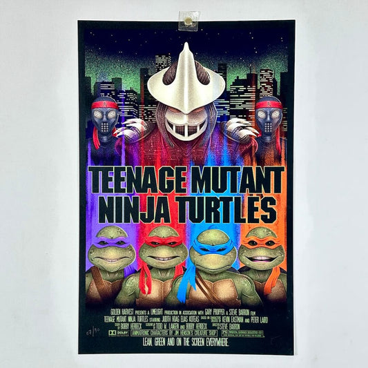 A vintage Teenage Mutant Ninja Turtles movie poster displayed against a light gray wall. 