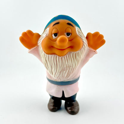 Toy figure of a character with a white beard and white outfit on a white background