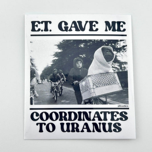 Sticker with black and white photo of people on bicycles and text 'E.T. Gave Me The Coordinates to Uranus"