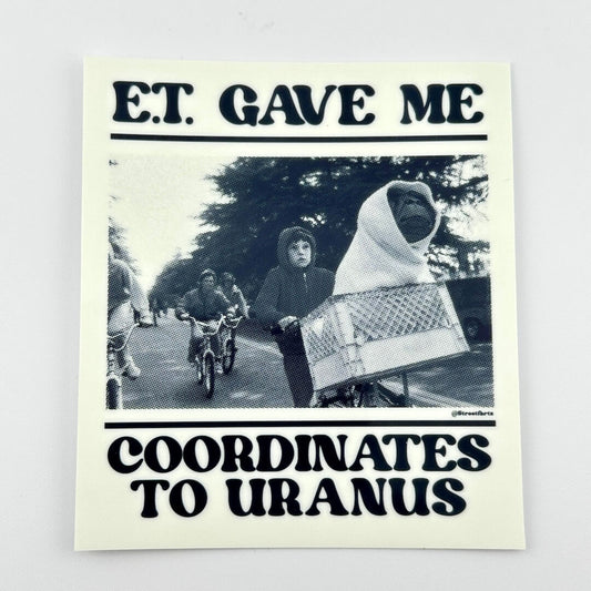 Sticker with black and white photo of people on bicycles and text 'E.T. Gave Me The Coordinates to Uranus"