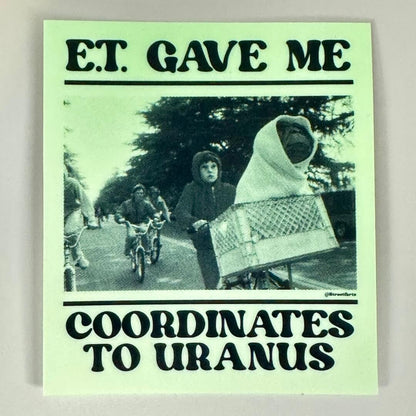 Sticker with black and white photo of people on bicycles and text 'E.T. Gave Me The Coordinates to Uranus"