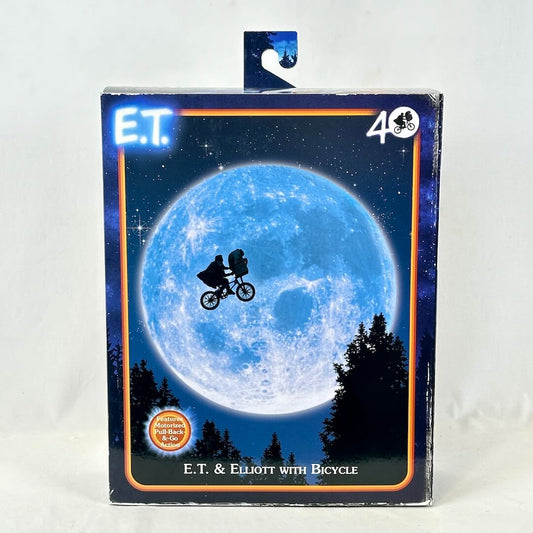 E.T. toy packaging with E.T. and Elliott on a bicycle against a moonlit sky.