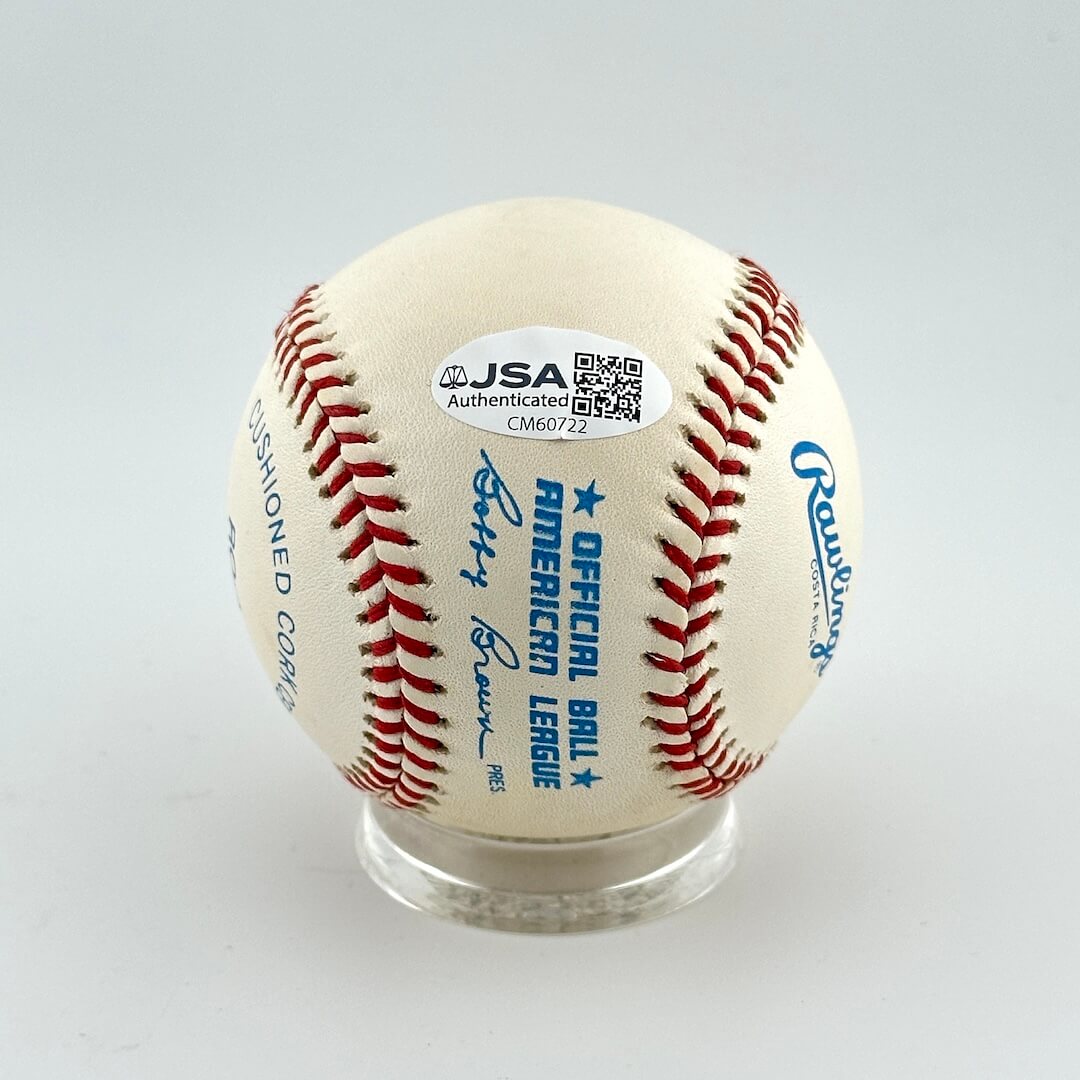 Baseball with Rawlings logo and authentication label on a gray background