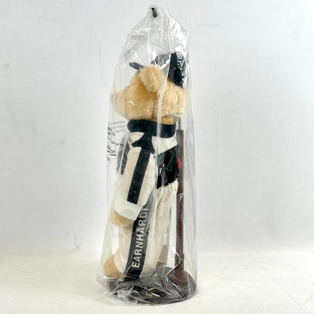 Plush toy in a clear plastic bag with visible branding on a white background