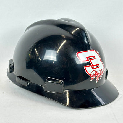Black helmet with a red and white logo on a light gray background