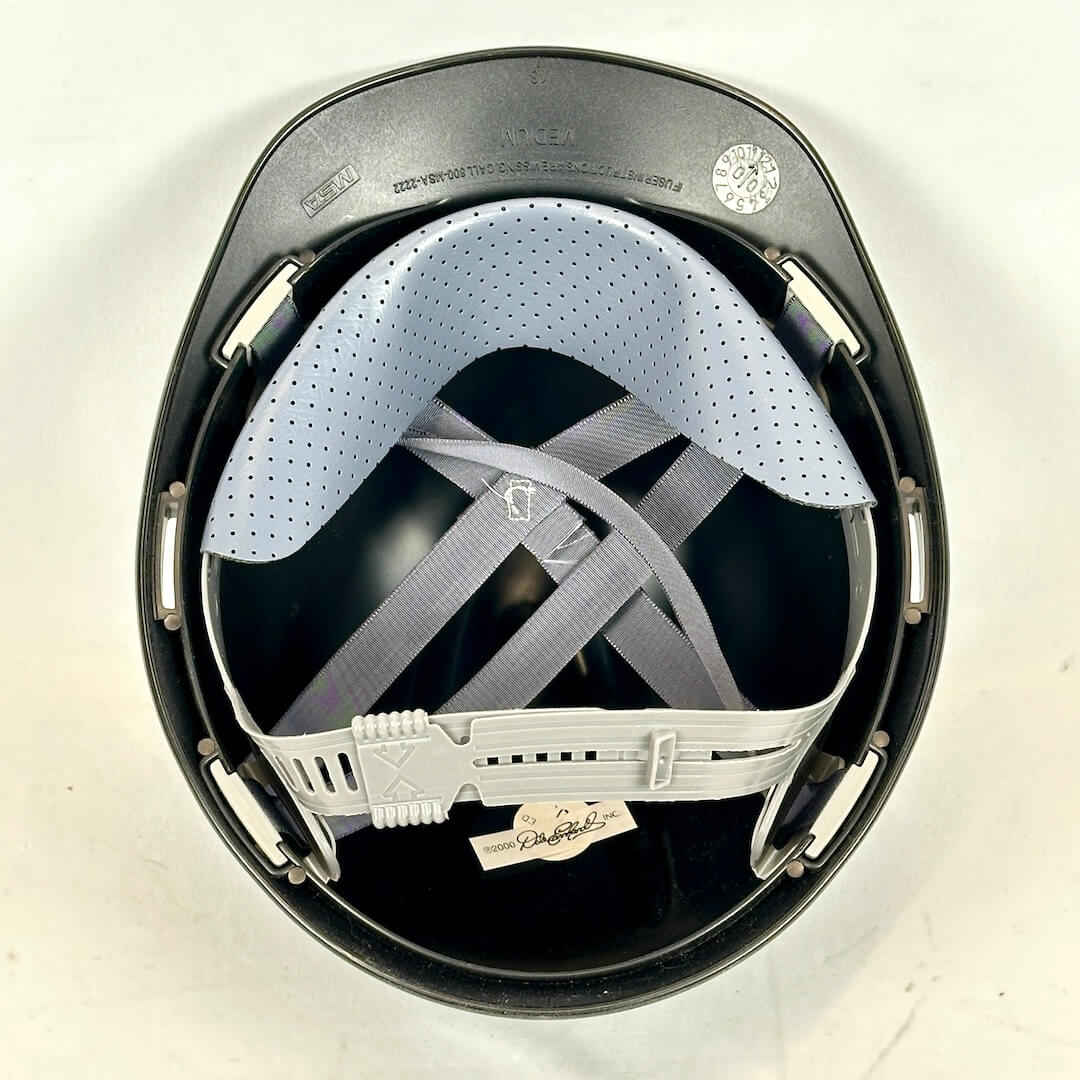 Black helmet with white interior and chin strap on a white background