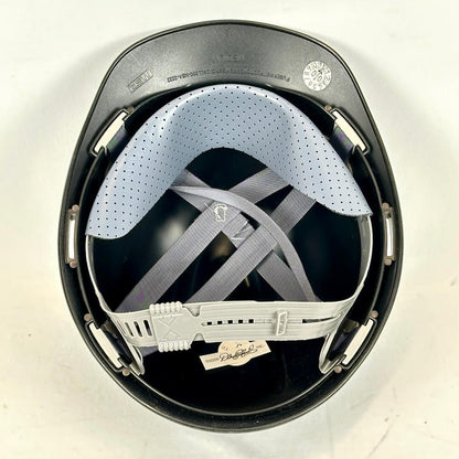 Black helmet with white interior and chin strap on a white background