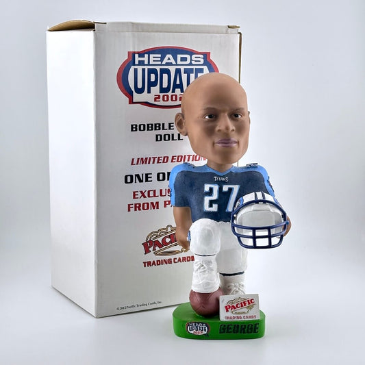 Bobblehead of football player in blue and white jersey with box against gray background. 