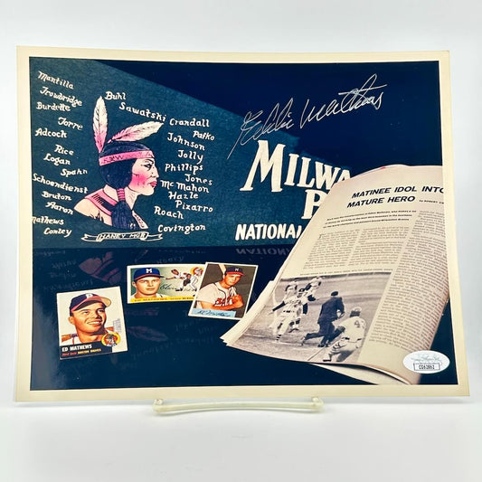 Baseball memorabilia display with player cards, newspaper cutout, and signature on a blue background.