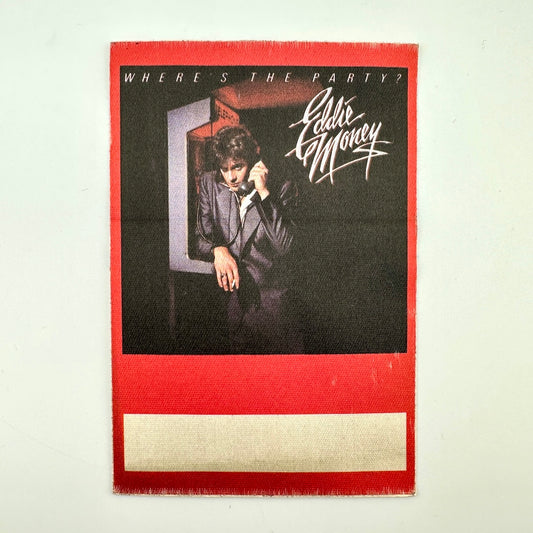 Red backstage pass with photo of Eddie Money at a payphone next to stylized text, "Eddie Money"