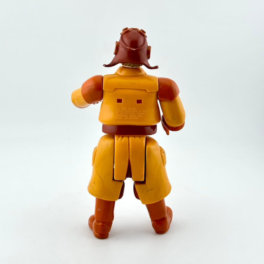 Toy figure with yellow and brown outfit on a white background