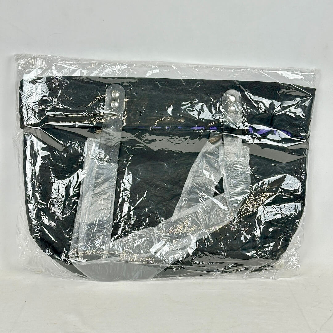 Black bag wrapped in clear plastic on a white background