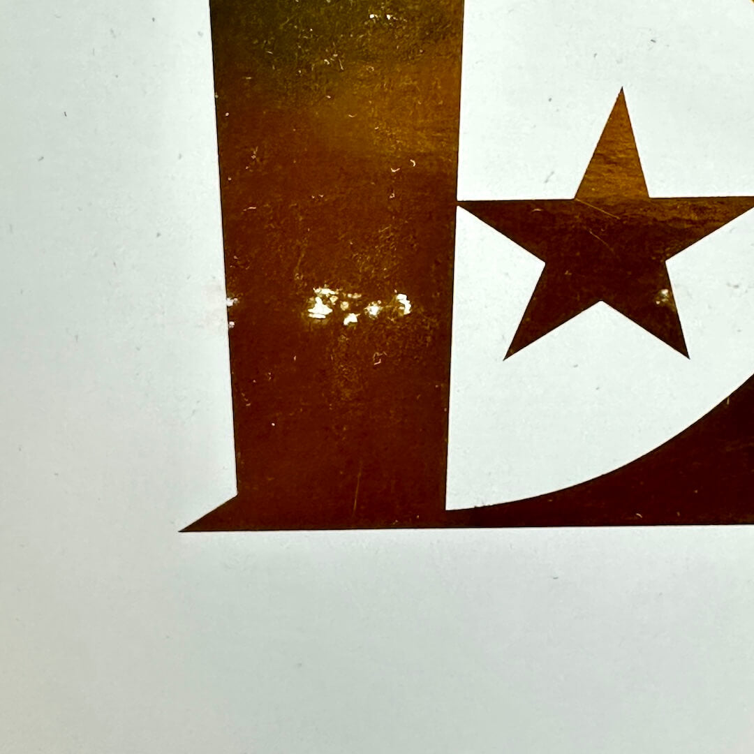 Close-up of a gold star design on a white background