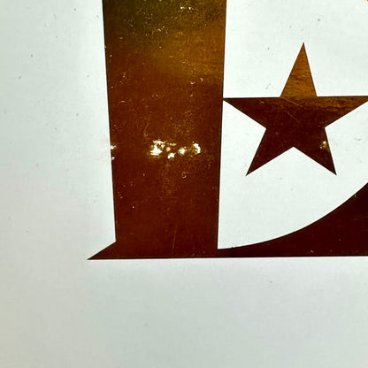 Close-up of a gold star design on a white background
