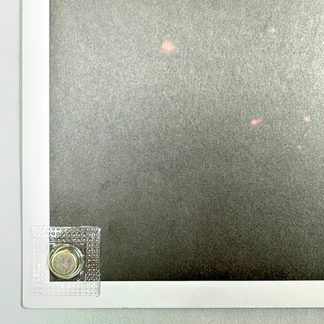 Close-up of bottom left corner of poster to show no visible damage. 