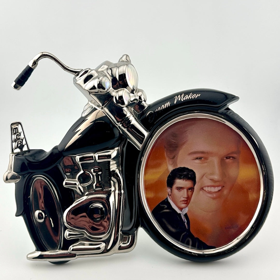 Motorcycle shaped ceramic plate with Elvis portrait in front wheel of him in the sunset & dressed in black in foreground.