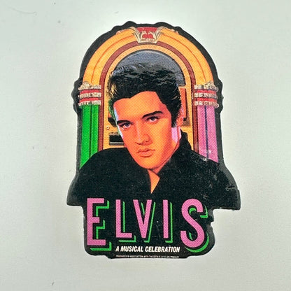 Pin of Elvis Presley in front of a jukebox with 'Elvis: A Musical Celebration' text on a white background