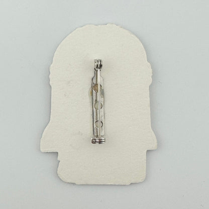 Backside of pin against white background. 